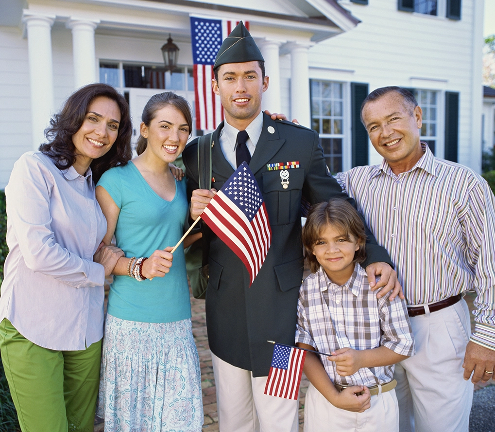 VA Home Loans - Veteran family in front of house